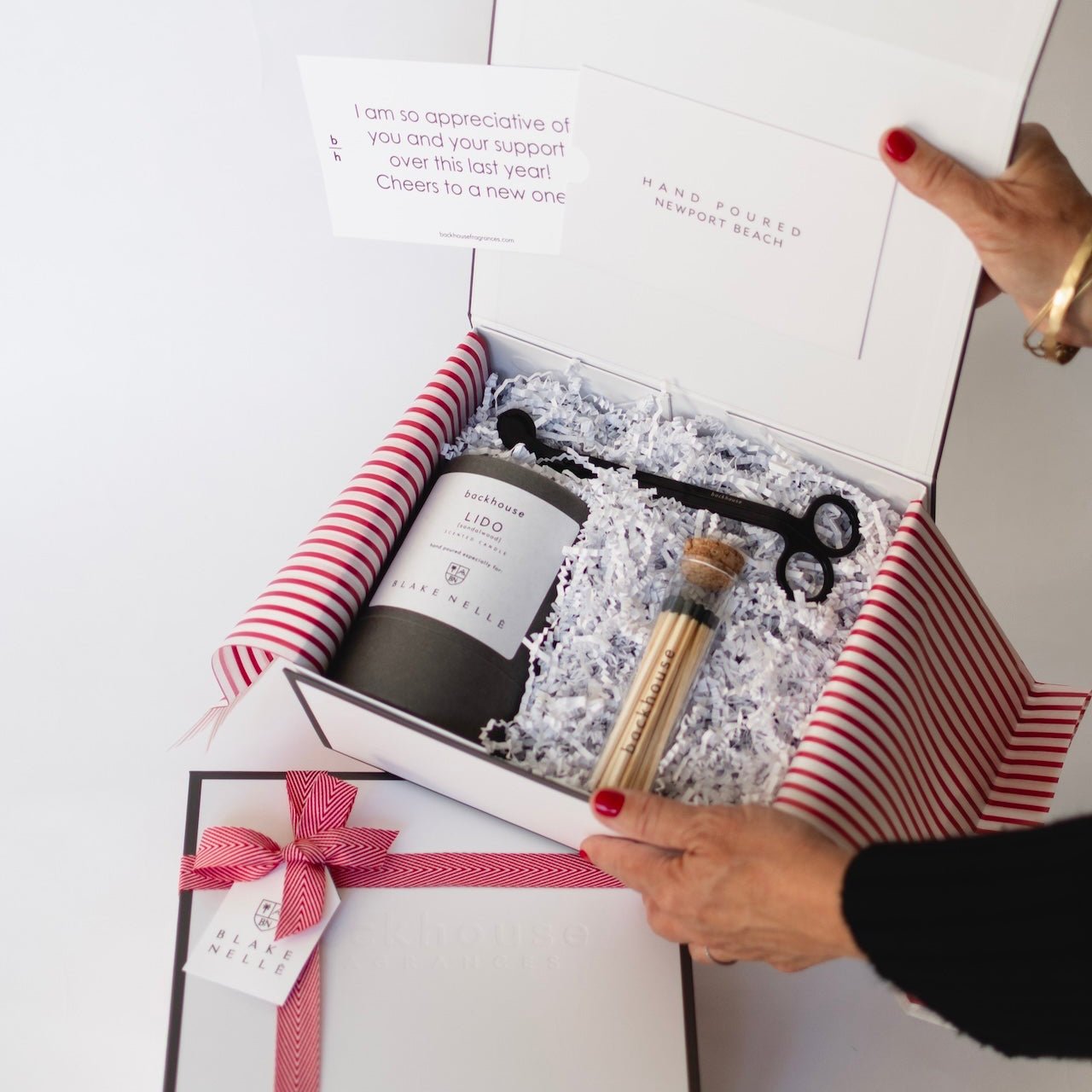 person holding corporate gift box open showing contents inside