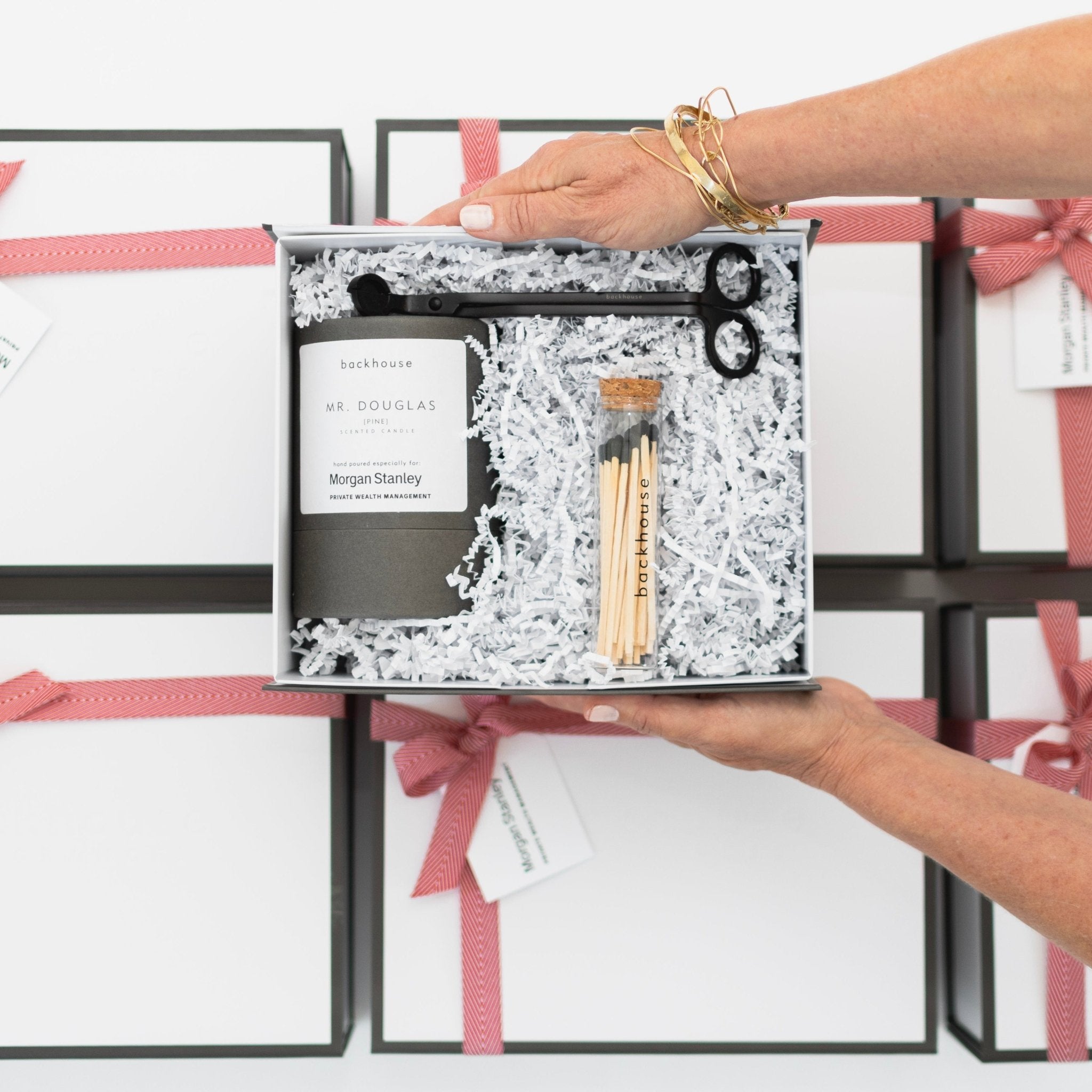 Custom corporate gift box opened with candle, matches and wick-trimmer. Featuring Morgan Stanley logo.