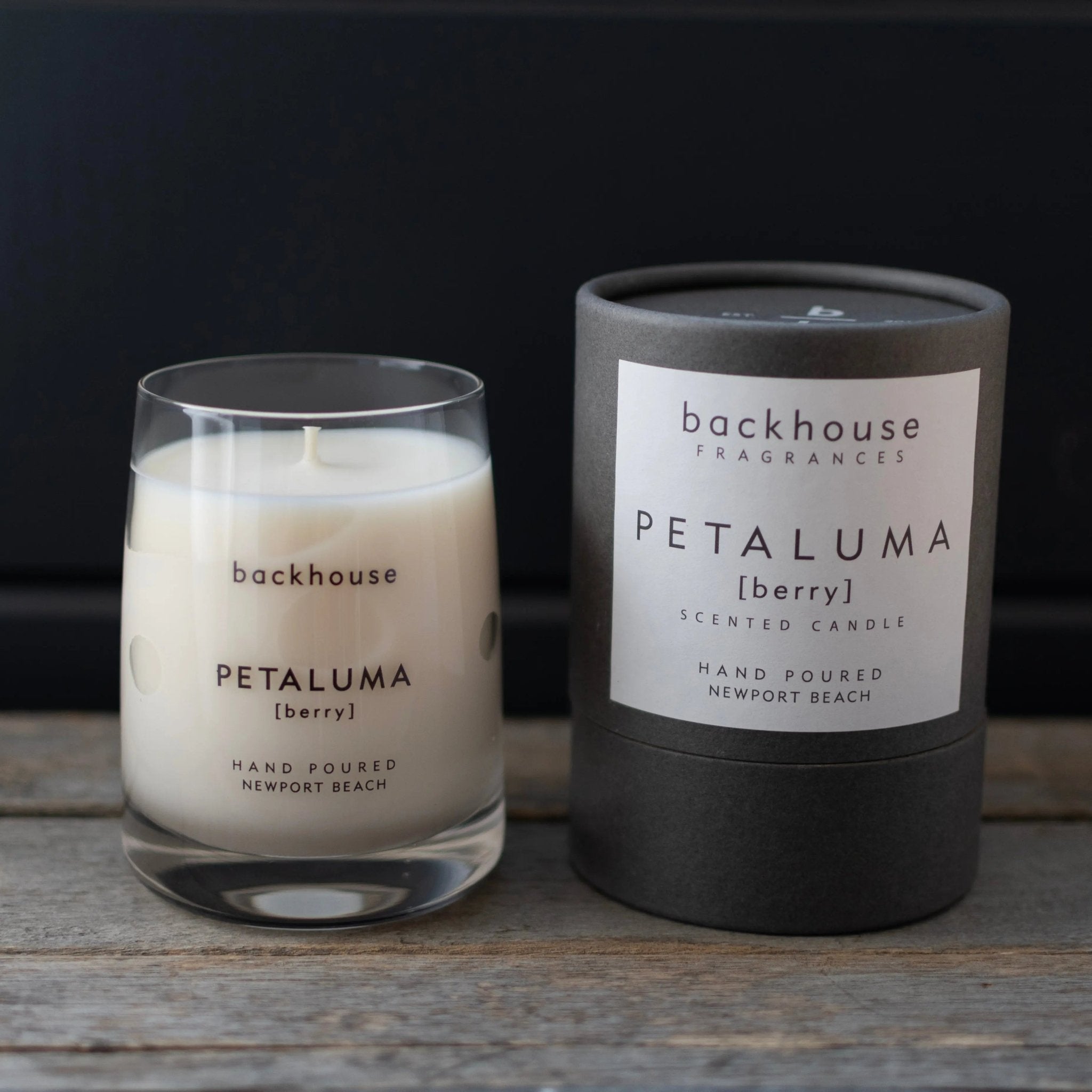 Petaluma berry candle by backhouse displayed with its signature cylinder box against a dark background.