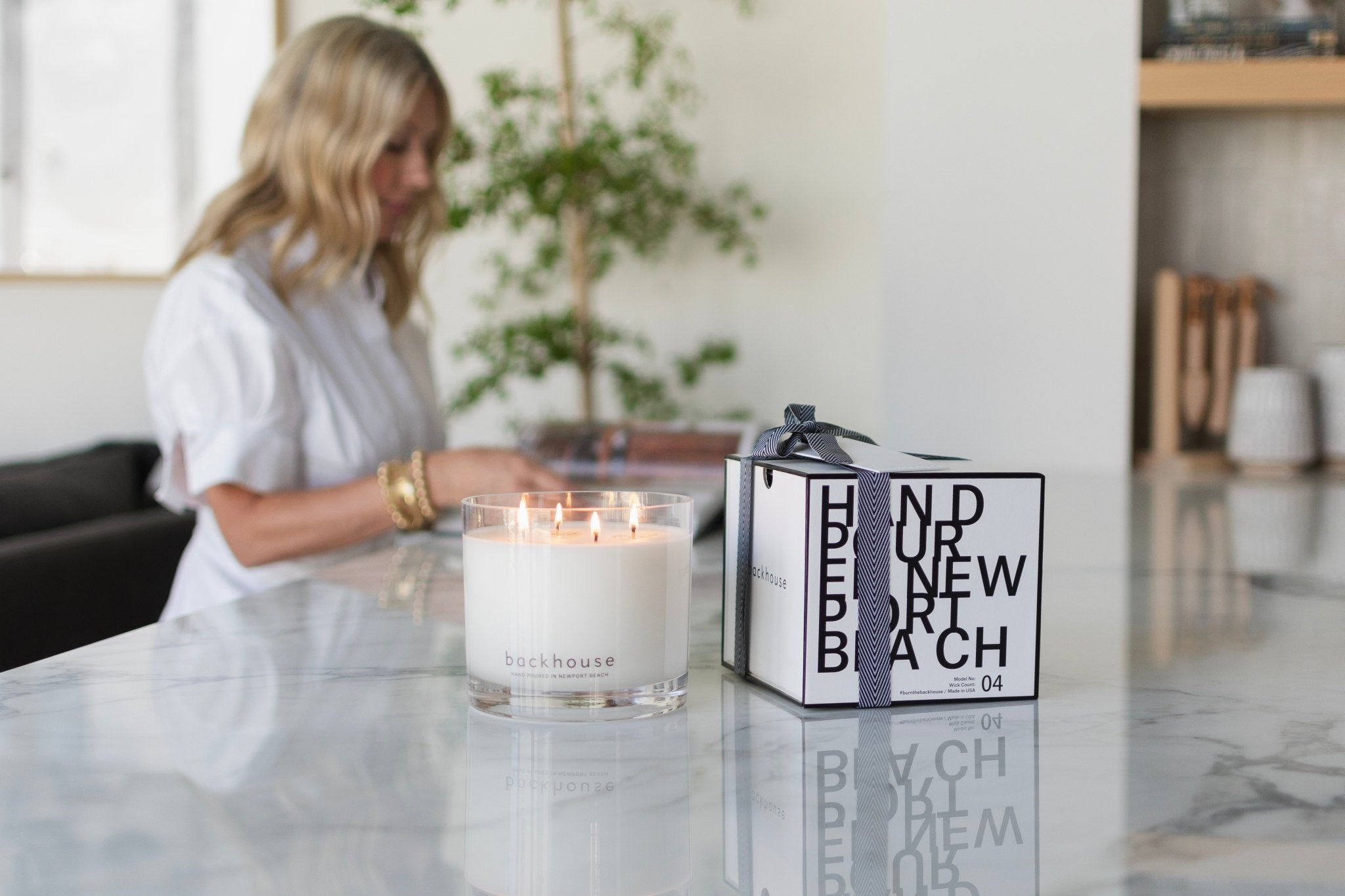 Backhouse Fragrances luxury scented candle and gift box styled on marble countertop — Newport Beach