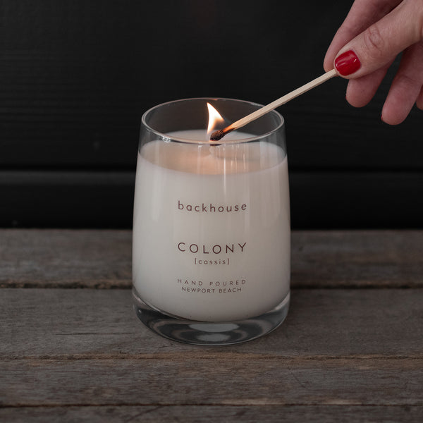 Modern Scented Candle | COLONY [cassis] | backhouse fragrances | candle being lit with match