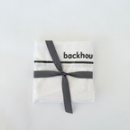 Classic dish towel by backhouse folded and wrapped with ribbon against a white background.