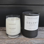 COLONY [cassis] candle with cylinder box on dark background. 
