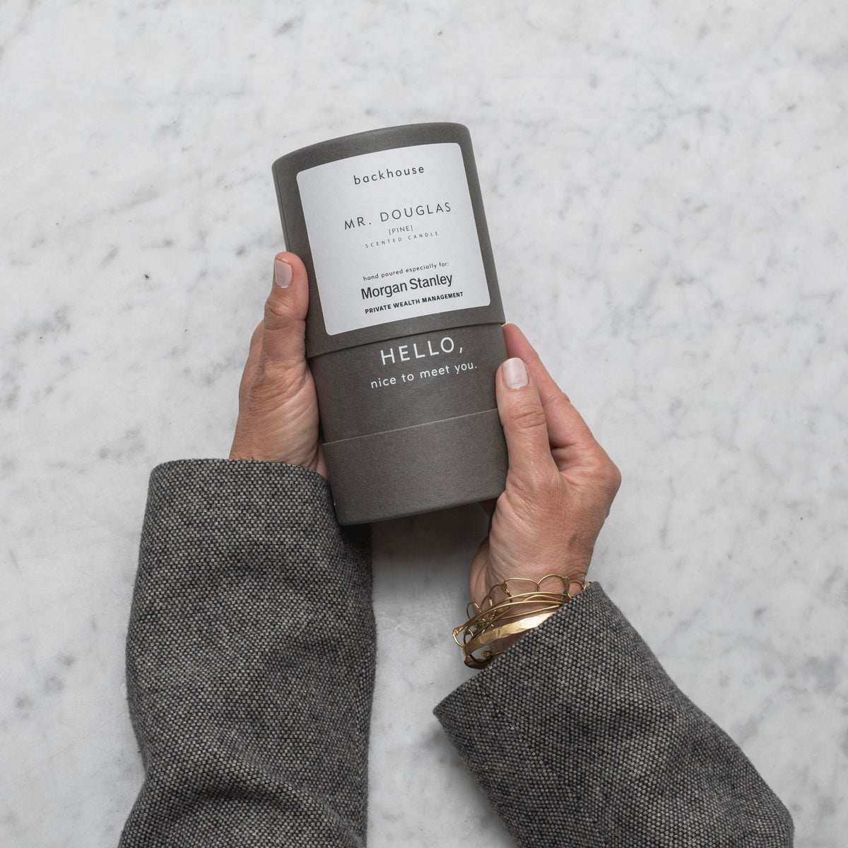 Backhouse Mr Douglas pine candle hand poured for Morgan Stanley Private Wealth Management held over marble surface