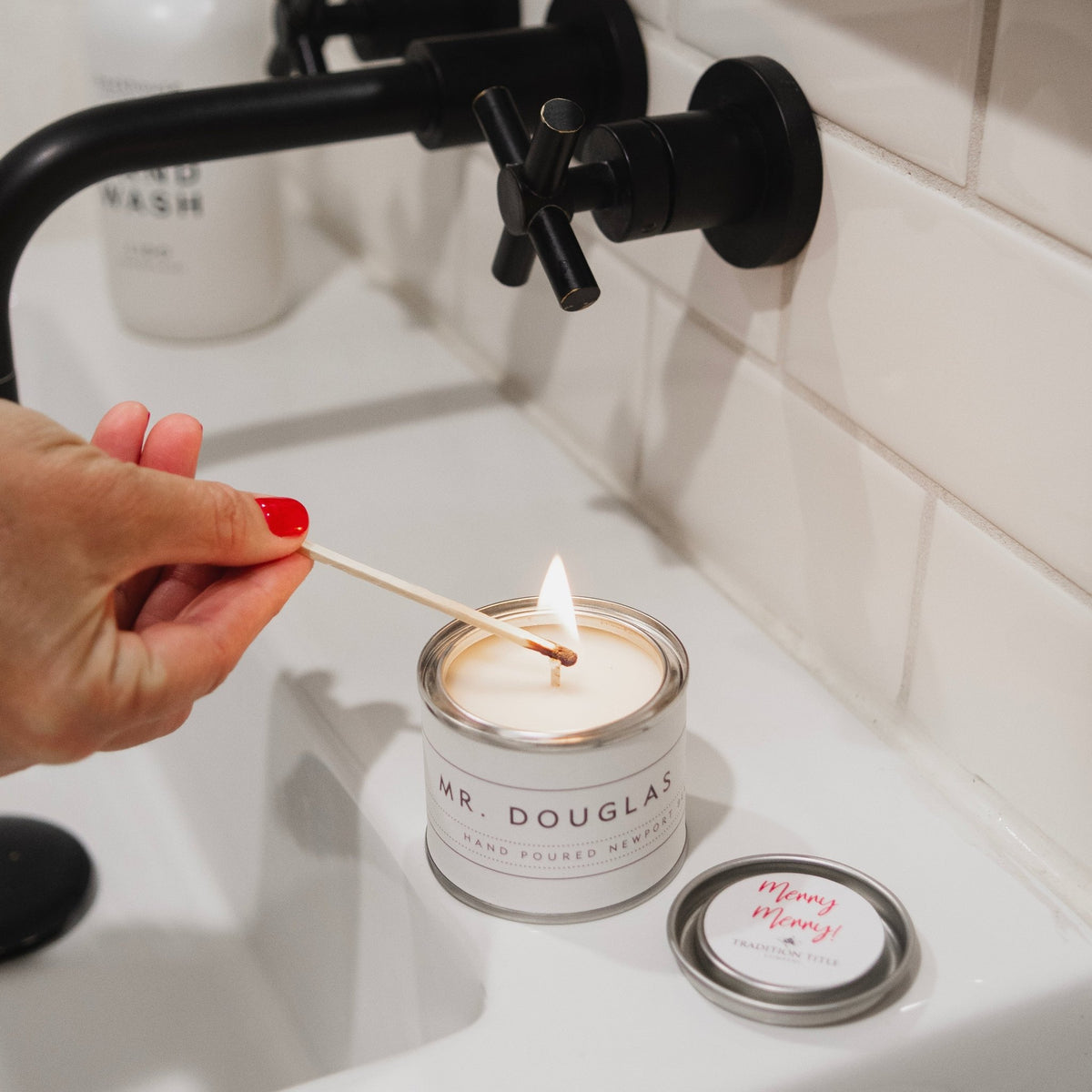 Backhouse Merry Merry christmas custom candle being lit in bathroom