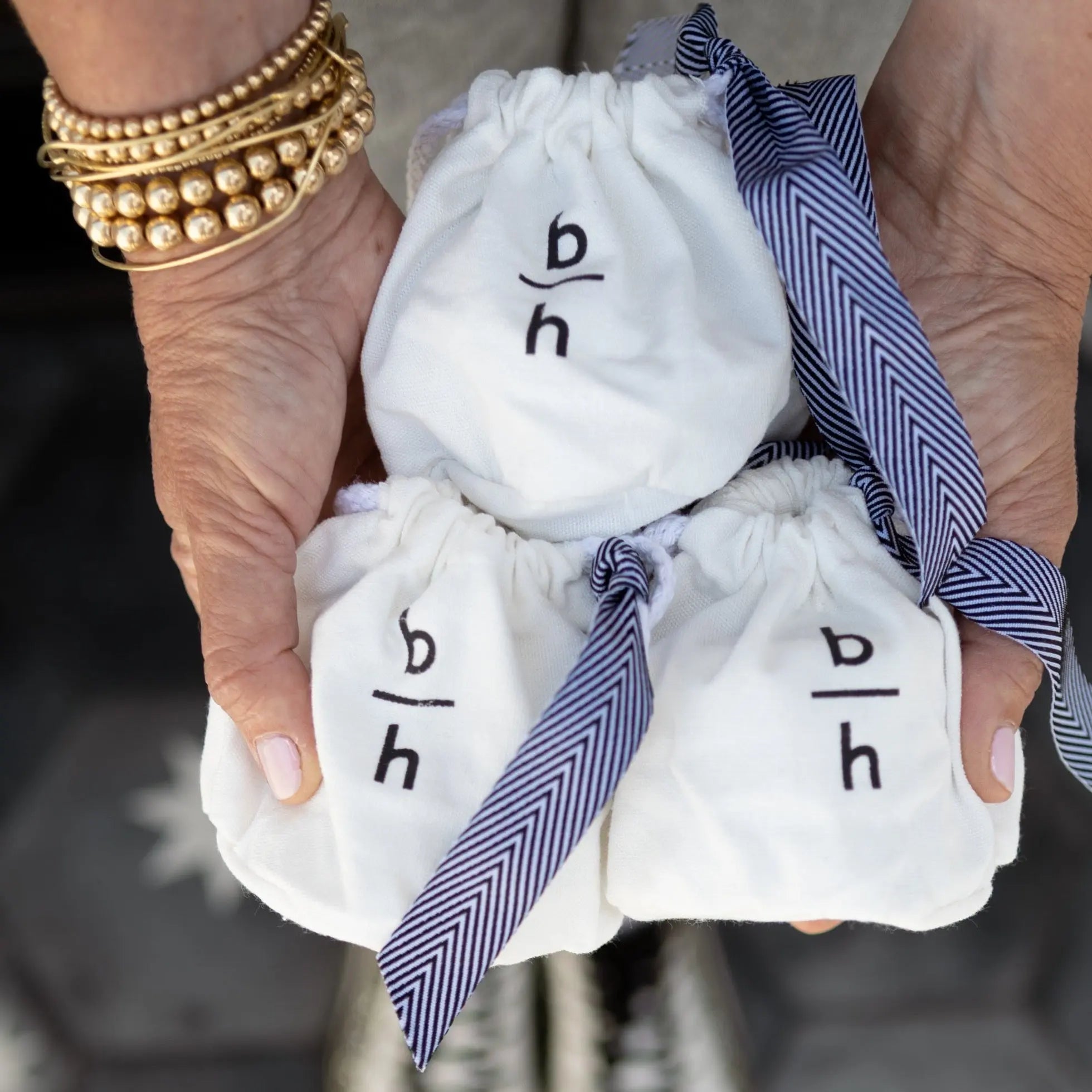 custom backhouse canvas gift bags and striped black ribbons used for packaging custom mini candle wedding favors.