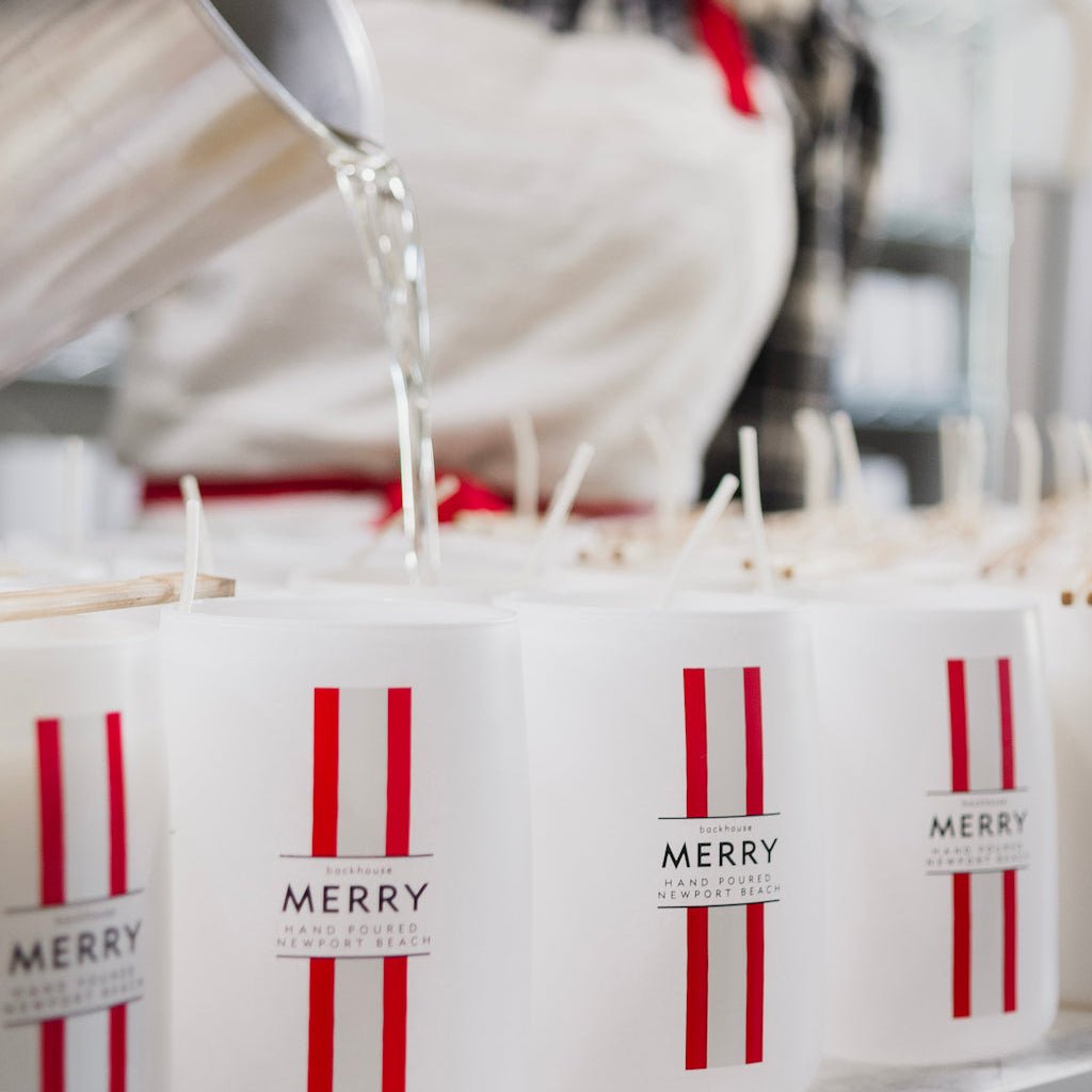 pouring merry pine cedar holiday candle white and red jar backhouse fragrances