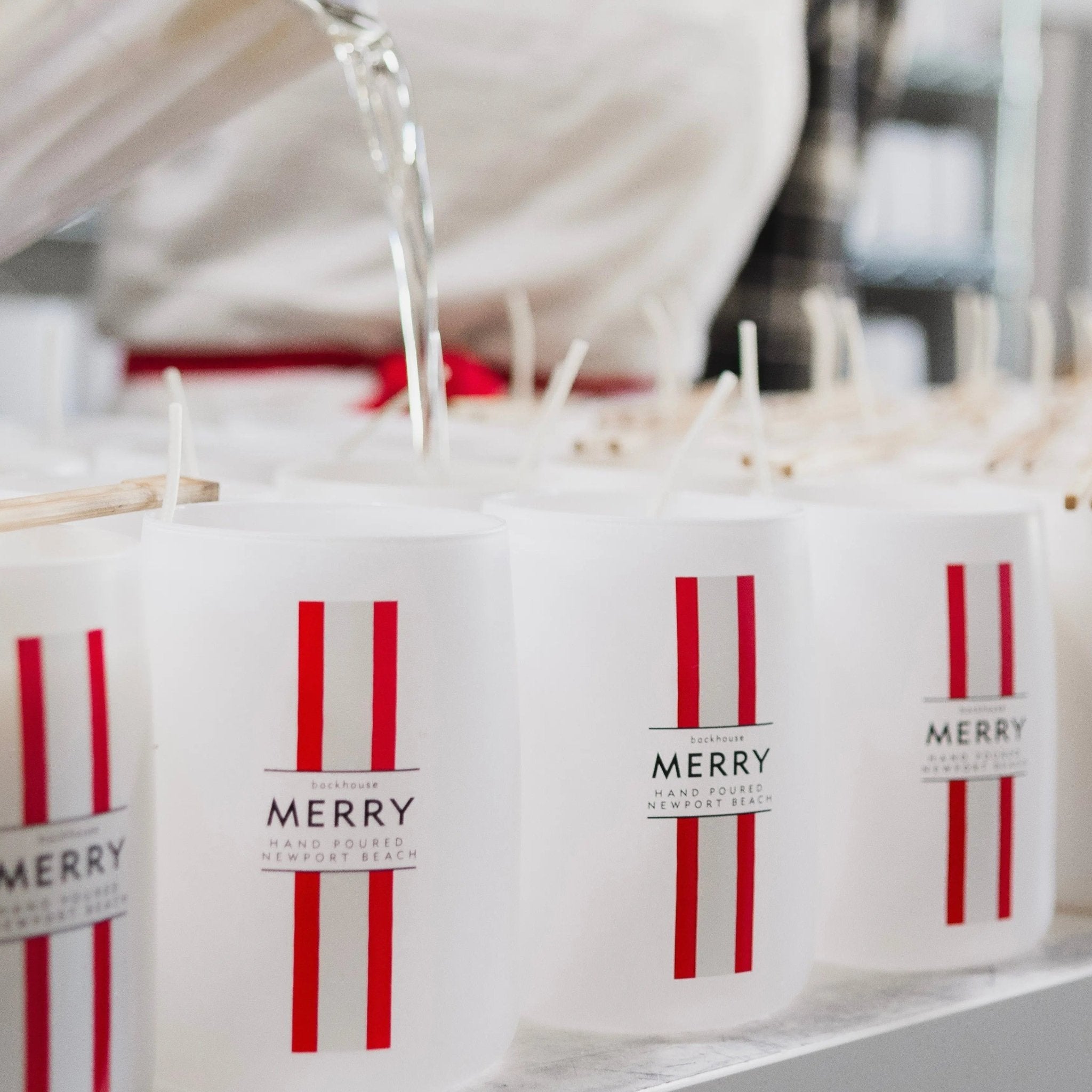 Backhouse team hand-pouring candles during the production process for Merry Mr. Douglas.