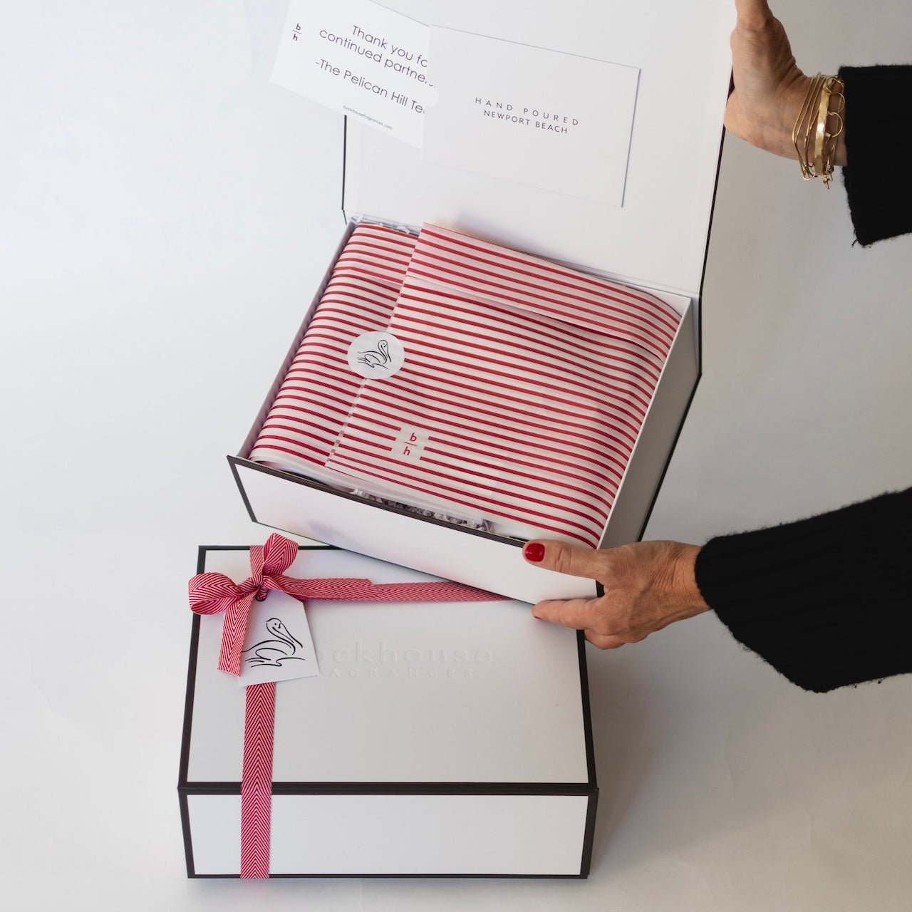 person holding gift box showing wrapping and custom sticker