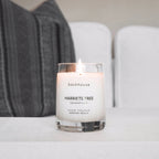Harriets Tree grapefruit hurricane candle by backhouse burning on a coffee table. Newport Beach